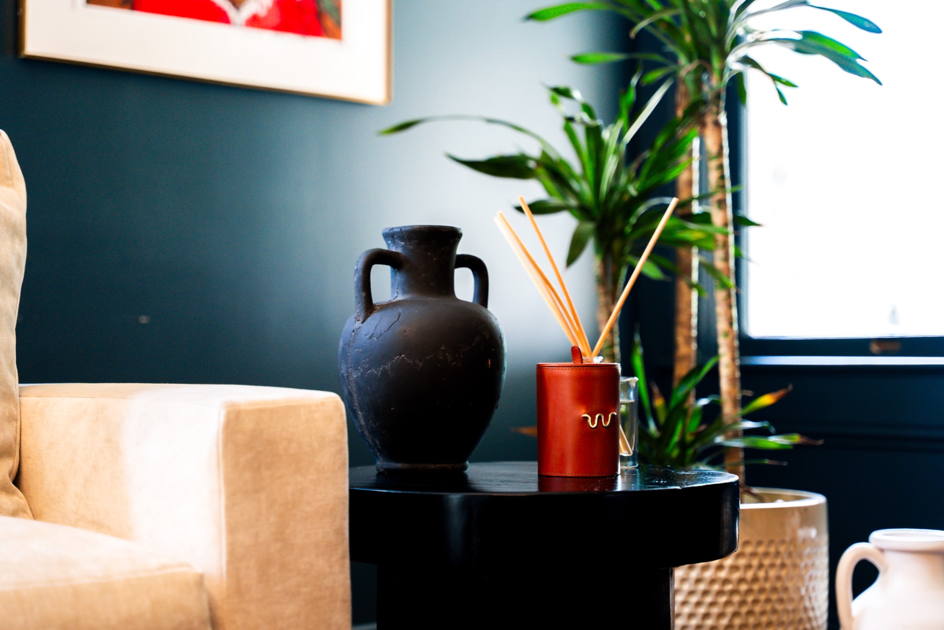 Side table styled with vintage pottery and brass details at Casa Thorman