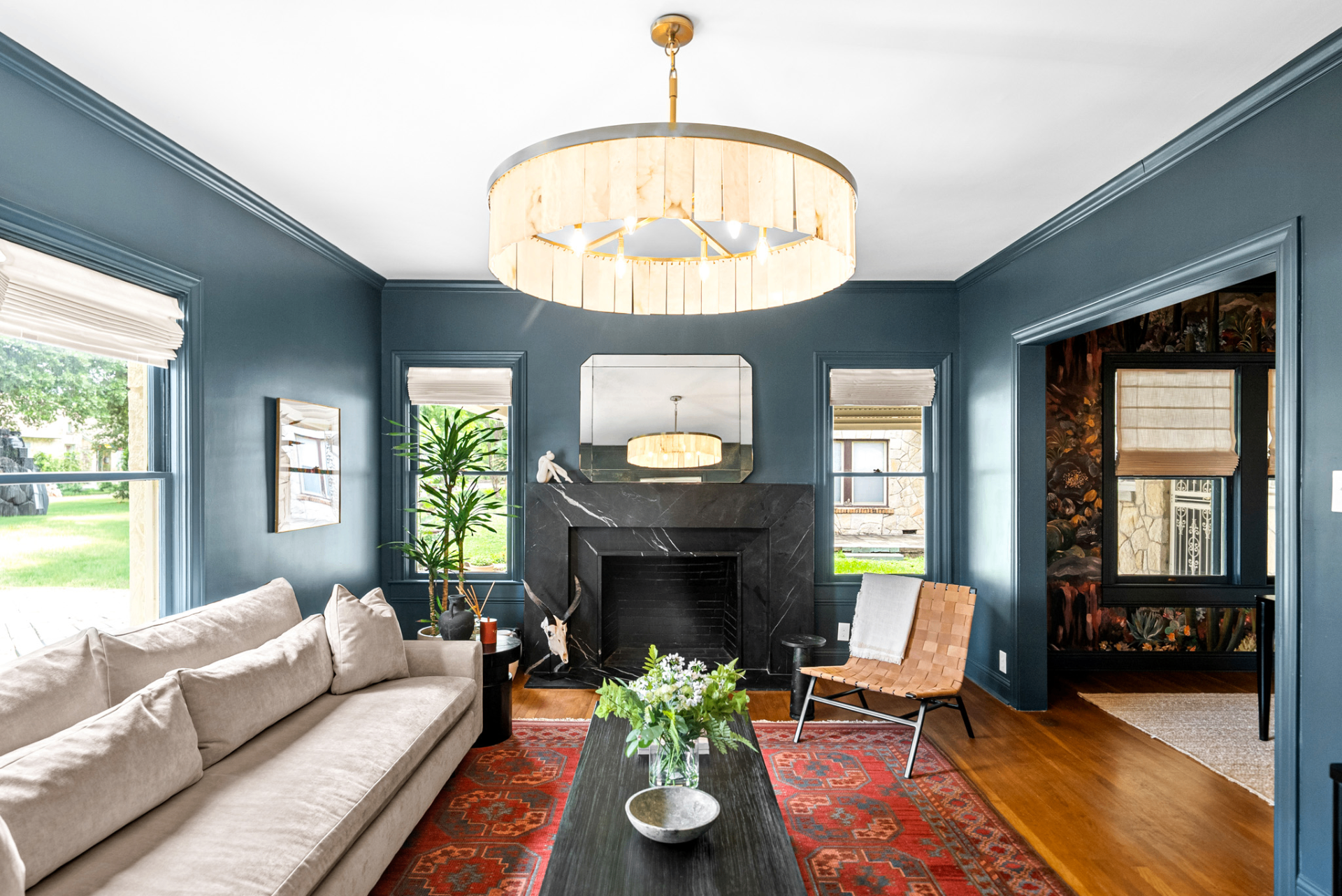 Living room with navy walls, original fireplace, and vintage rug at Casa Thorman
